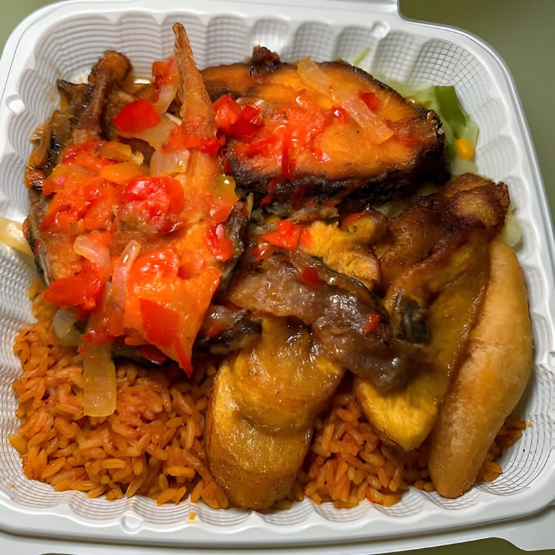 Nigerian jollof rice with fried fish, plantains, and a red pepper and onion sauce in a takeout container.